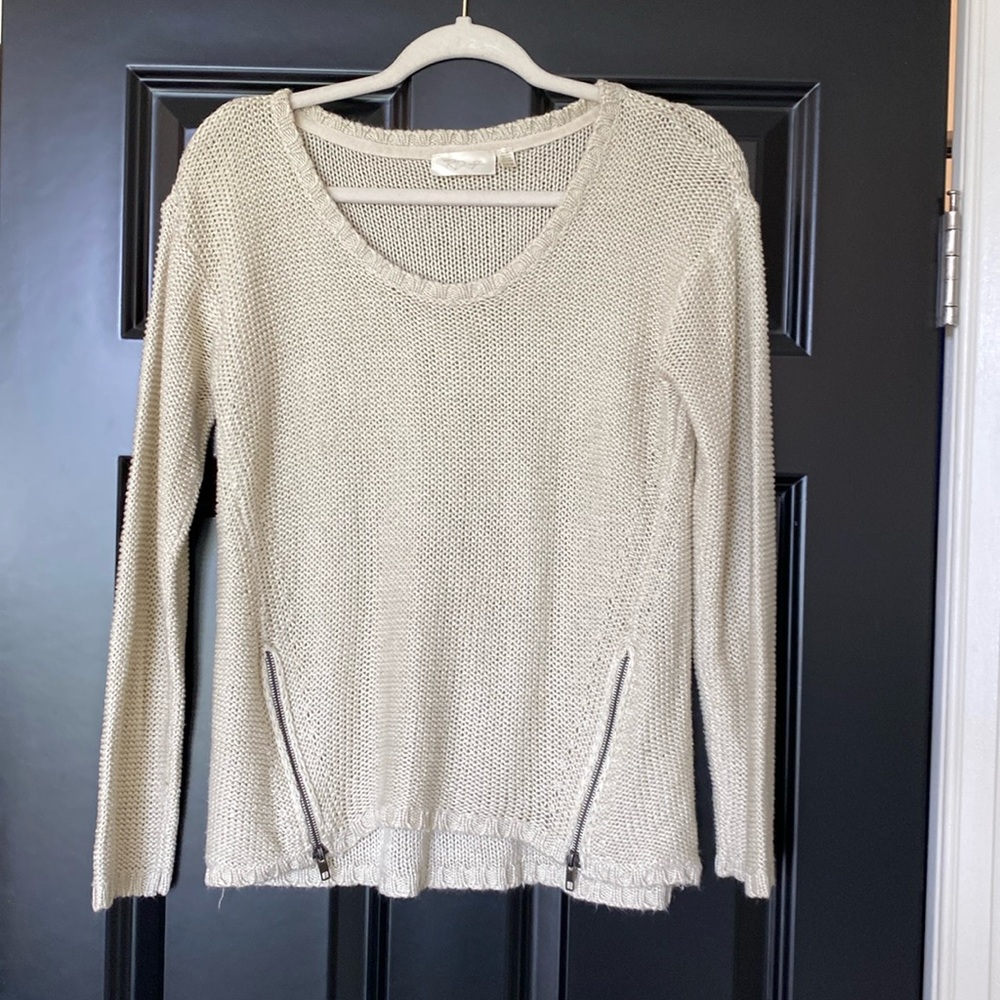 Cream sweater with zippers at the bottom. Super cute on!